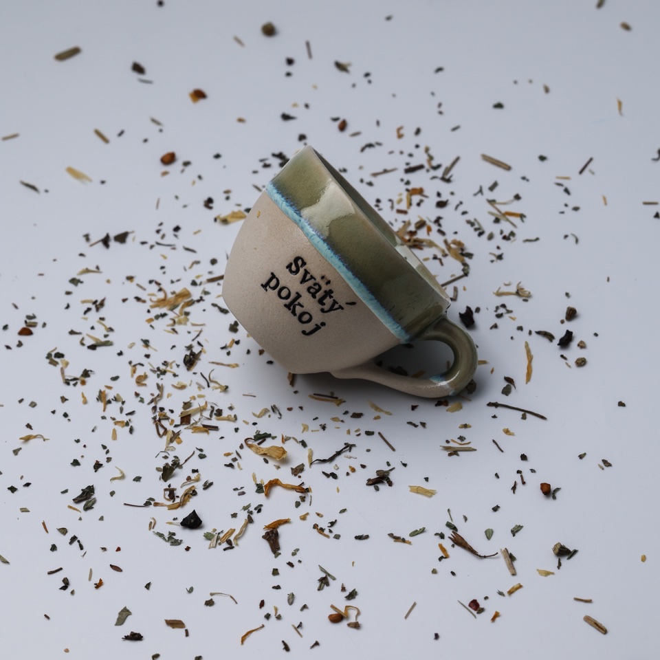 Handmade ceramic cup styled with loose tea leaves – photography by Filip Labanc for No Smile Needed