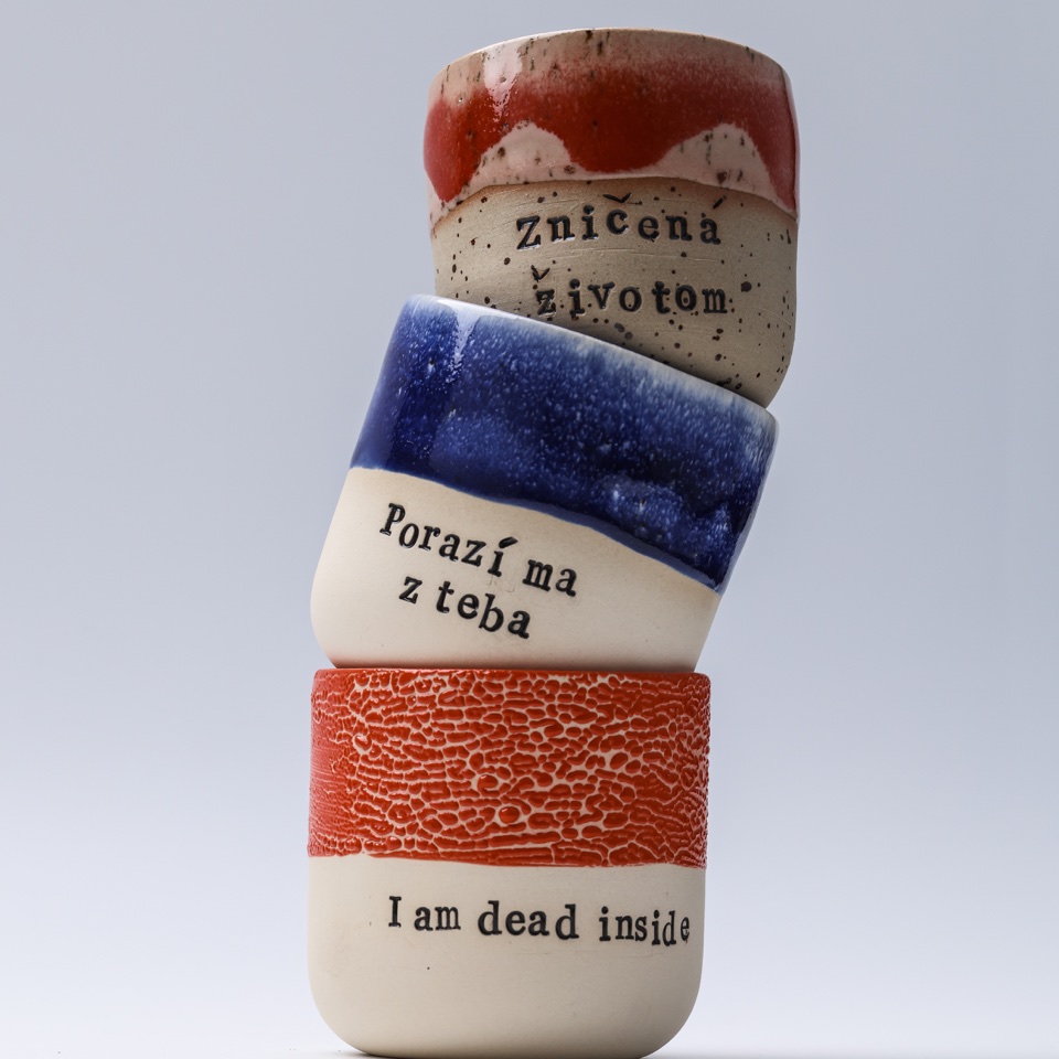 Stacked handmade ceramic cups with red and blue glazes – photography by Filip Labanc for No Smile Needed